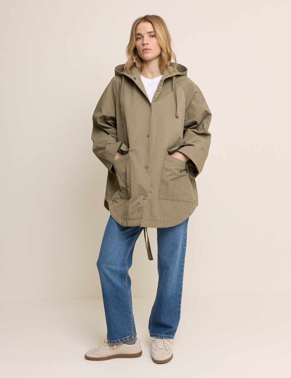 Women's olive green hooded parka jacket with long sleeves and utility pockets