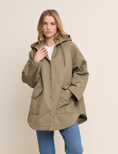 Women's olive green hooded parka jacket with long sleeves and utility pockets