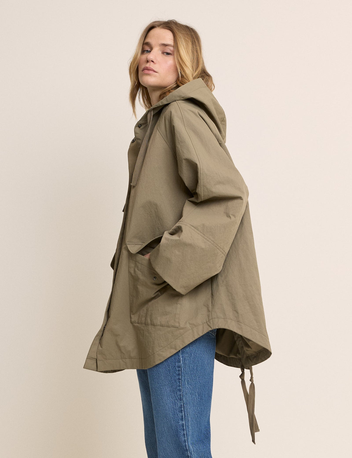 Women's olive green hooded parka jacket with long sleeves and utility pockets