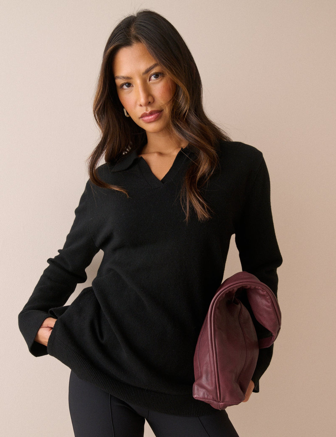 Women's black long-sleeve V-neck jumper with open collar and ribbed trims