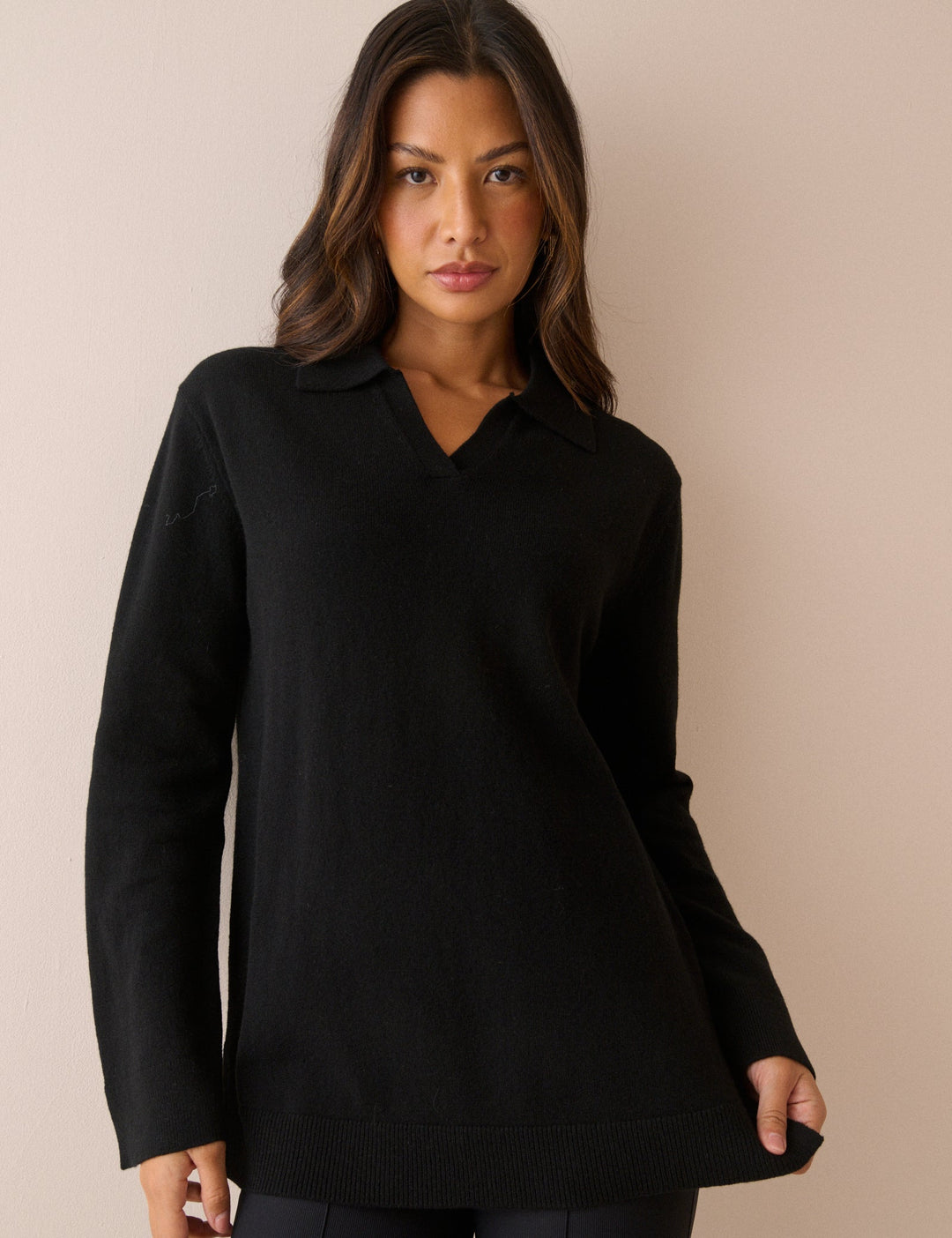 Women's black long-sleeve V-neck jumper with open collar and ribbed trims