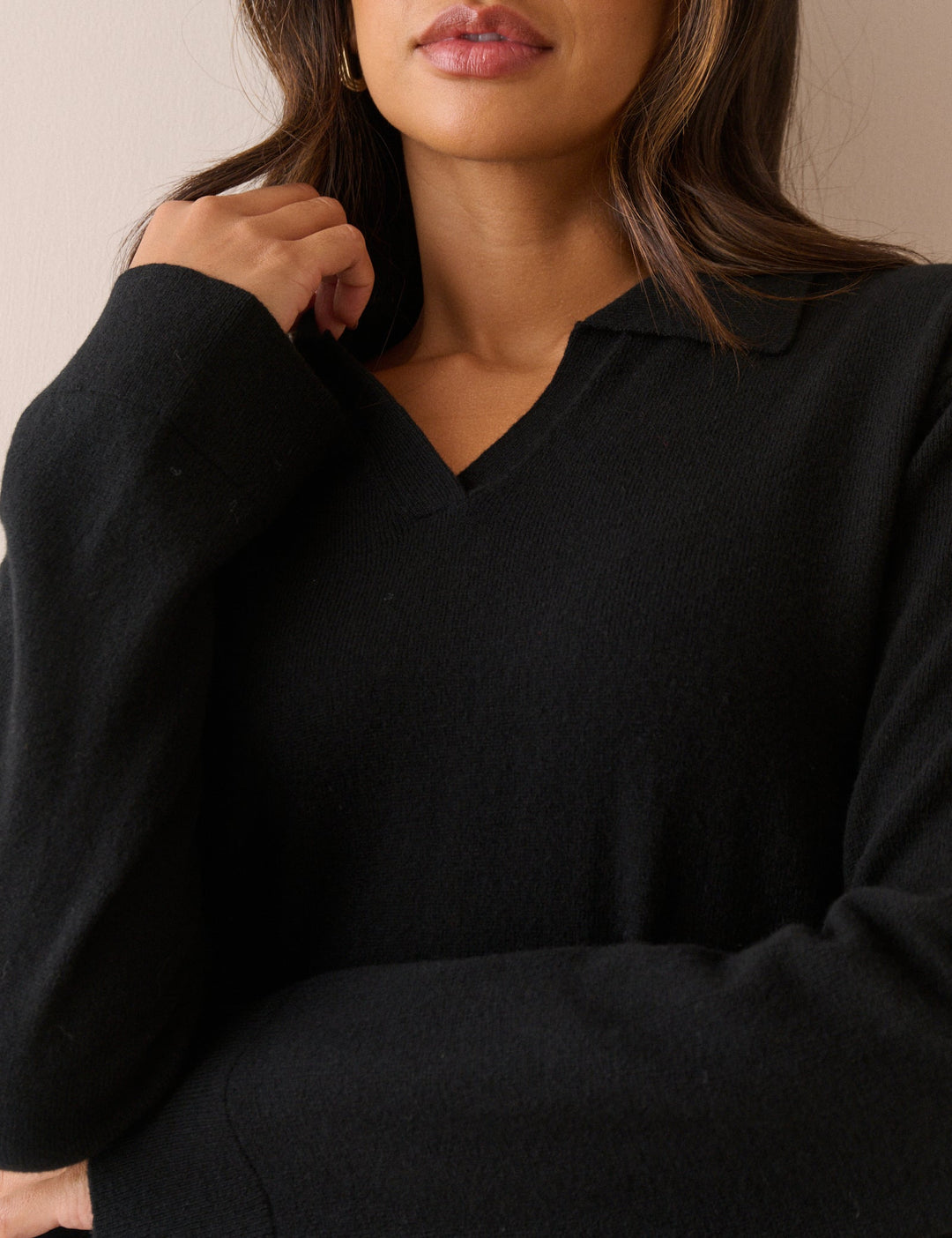 Women's black long-sleeve V-neck jumper with open collar and ribbed trims