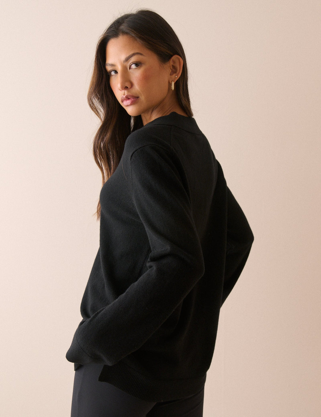 Women's black long-sleeve V-neck jumper with open collar and ribbed trims