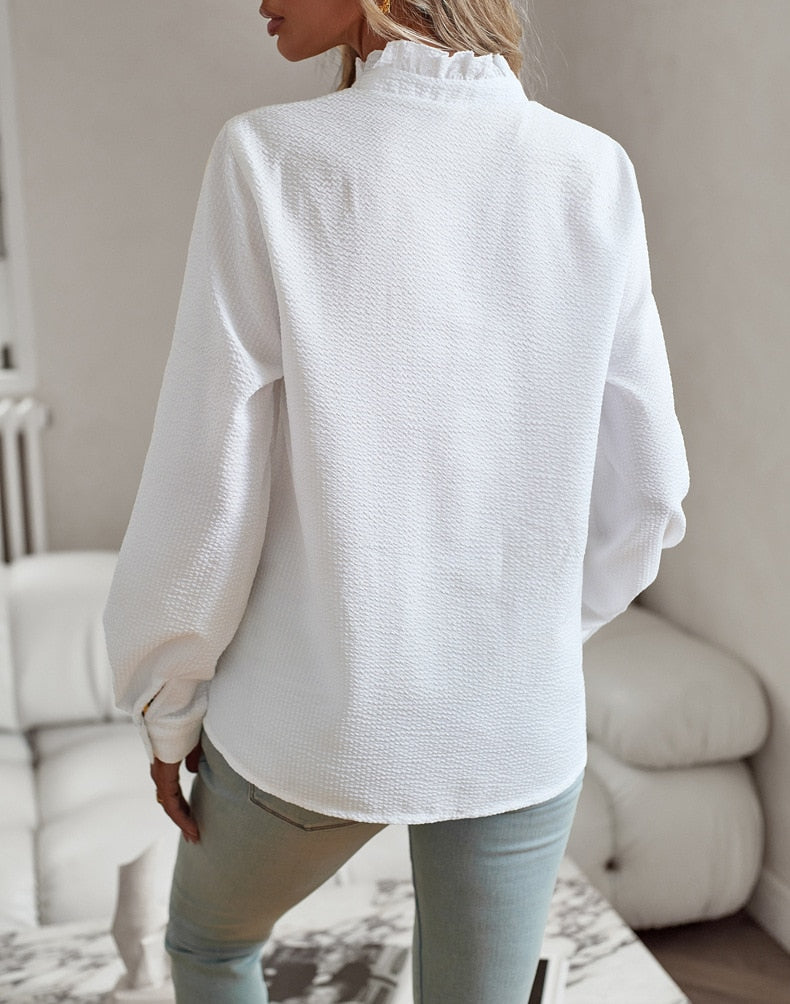 Women's long-sleeve textured blouse with a ruffled Mandarin collar and button front