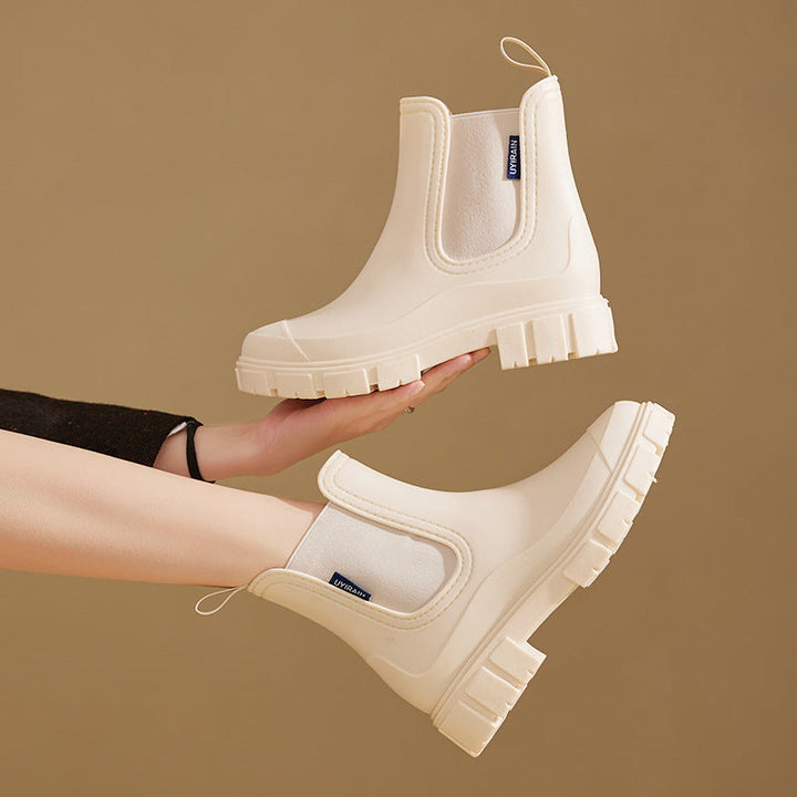 Women's waterproof chelsea ankle boots with chunky lug sole and pull loops, shown in pink and black