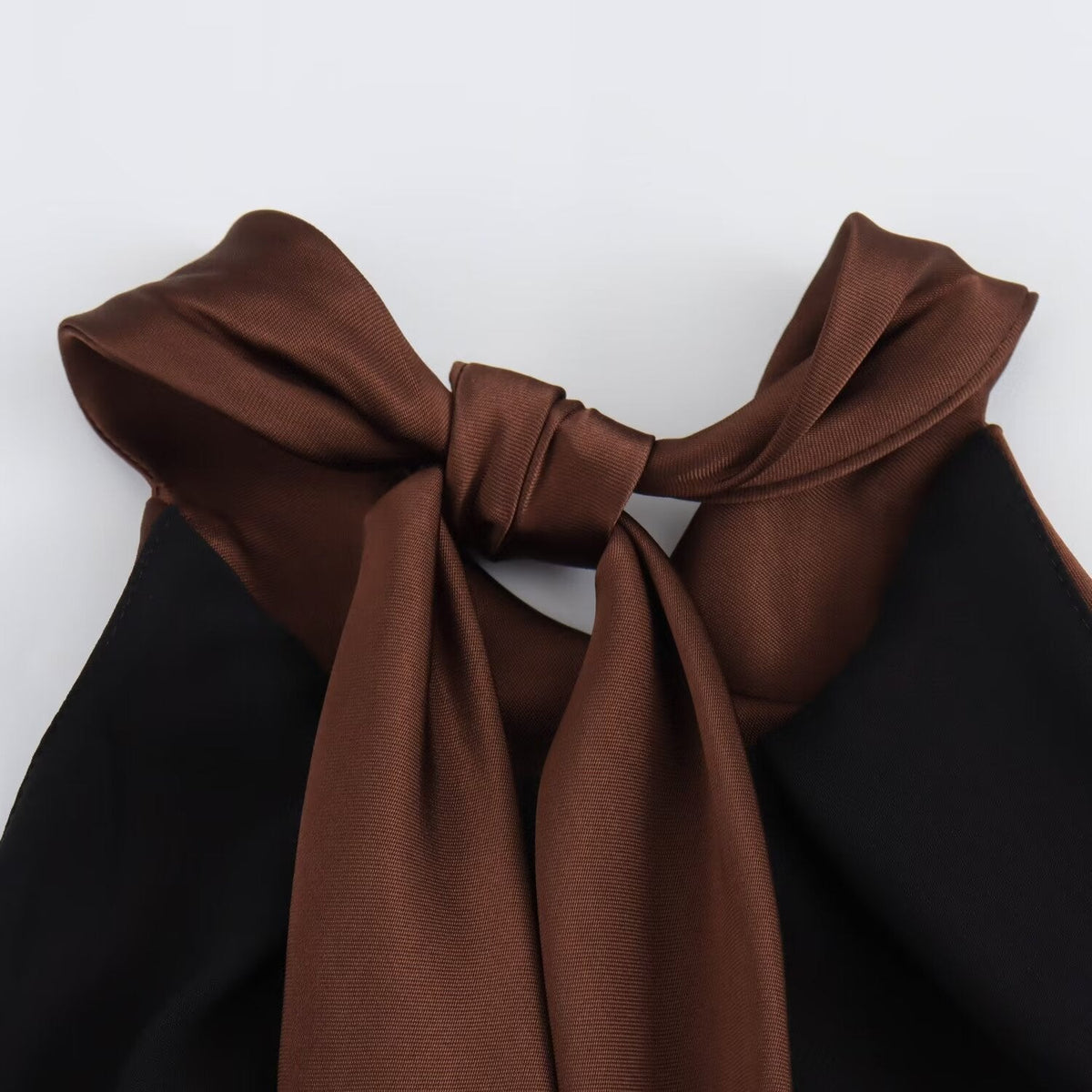 Women's brown sleeveless halter maxi dress with a floor-length skirt