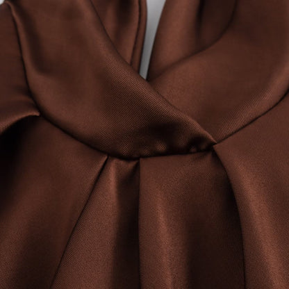Women's brown sleeveless halter maxi dress with a floor-length skirt