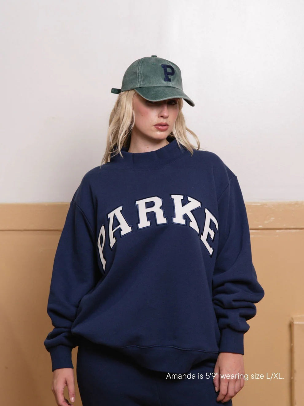 Women's oversized varsity sweatshirt with mock neck and front lettering
