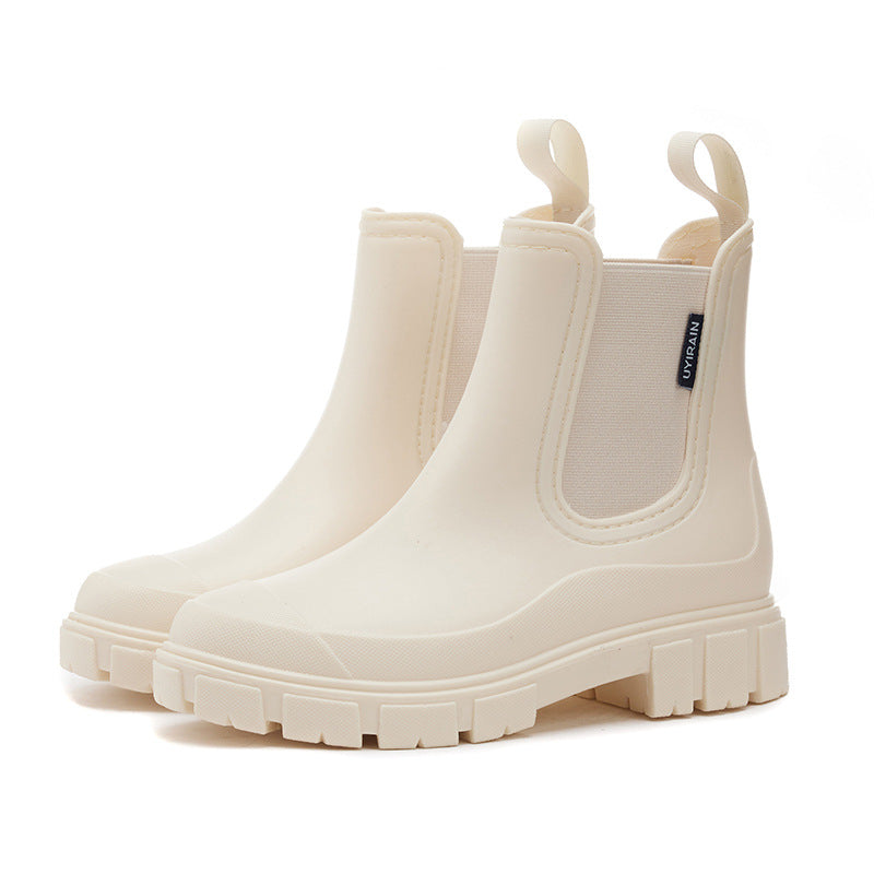 Women's waterproof chelsea ankle boots with chunky lug sole and pull loops, shown in pink and black