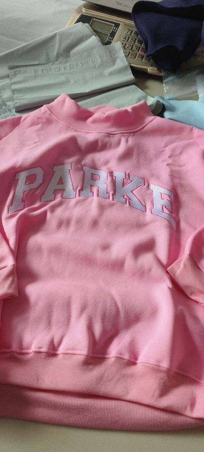 Women's oversized varsity sweatshirt with mock neck and front lettering