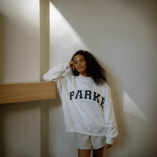 Women's oversized varsity sweatshirt with mock neck and front lettering