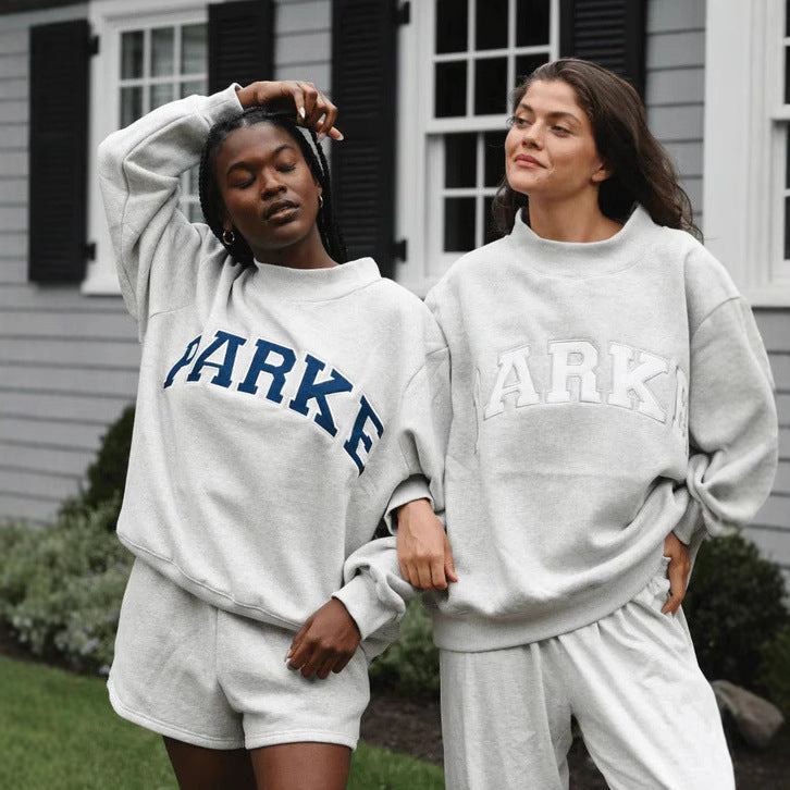 Women's oversized varsity sweatshirt with mock neck and front lettering