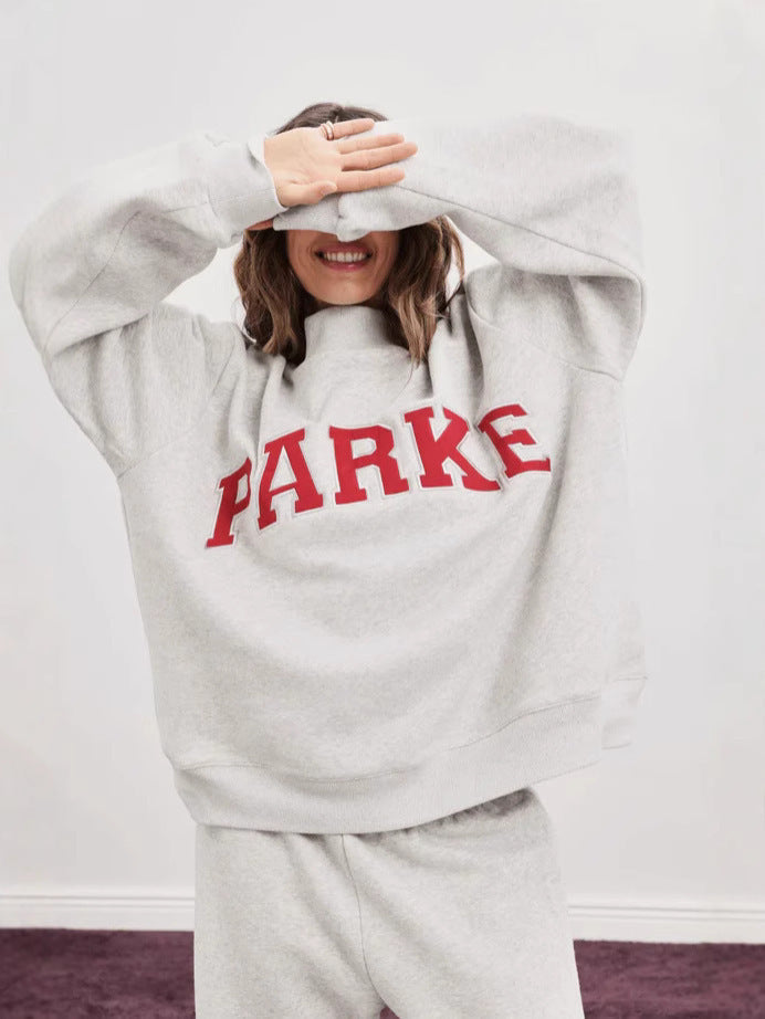 Women's oversized varsity sweatshirt with mock neck and front lettering