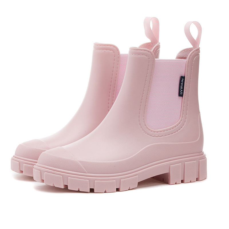Women's waterproof chelsea ankle boots with chunky lug sole and pull loops, shown in pink and black
