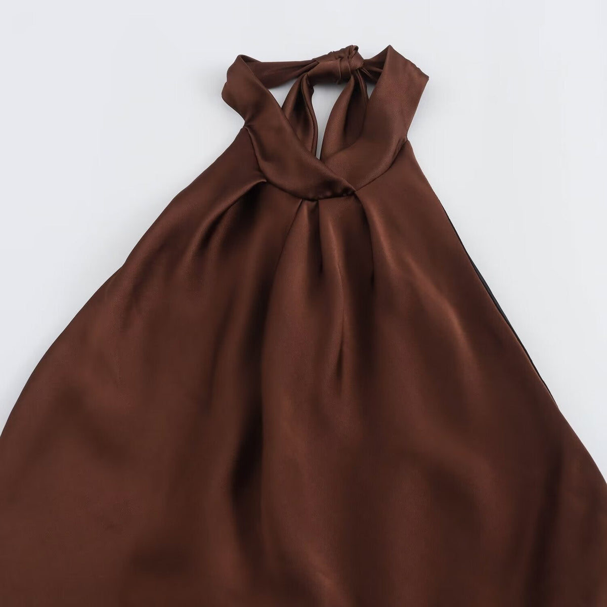 Women's brown sleeveless halter maxi dress with a floor-length skirt