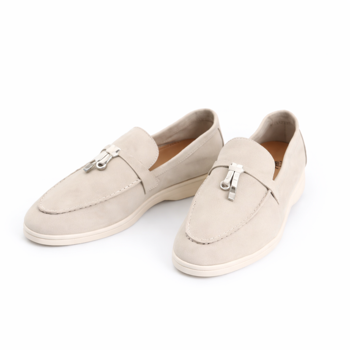 Women's slip-on loafers with flat soles, stitched toes and metal vamp trim