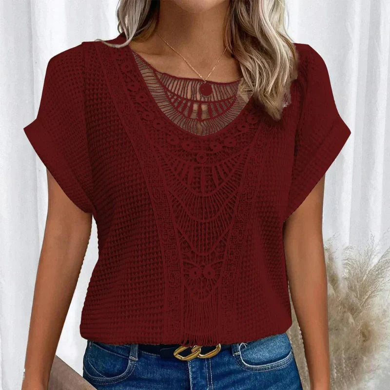 Woman wearing a relaxed waffle-knit top with an open crochet panel down the front and rolled cap sleeves