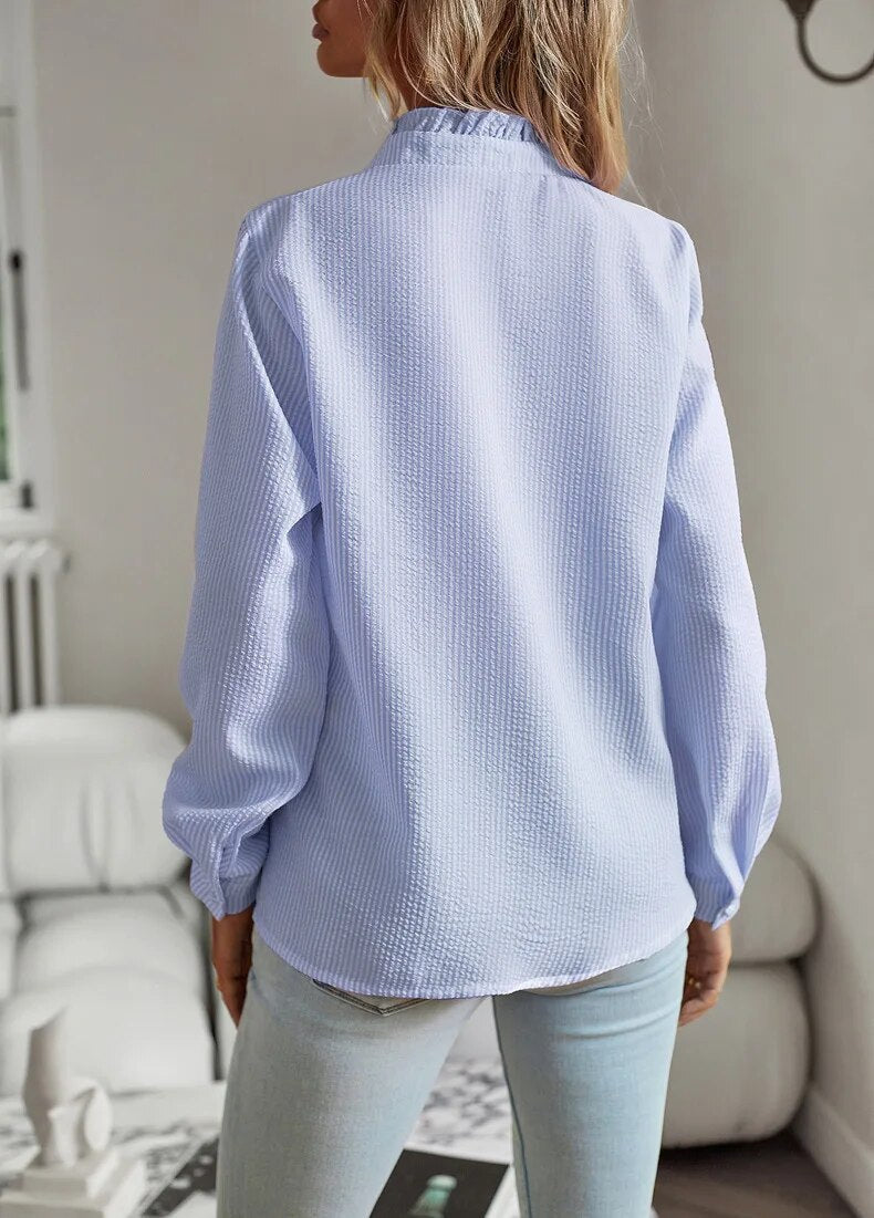 Women's long-sleeve textured blouse with a ruffled Mandarin collar and button front