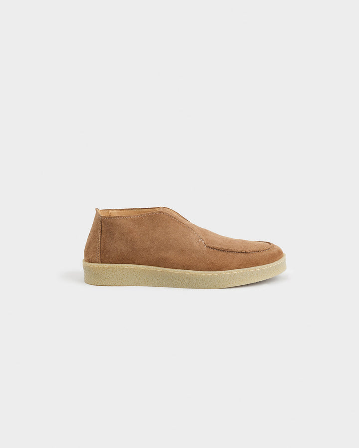 Men's brown moc toe ankle boots with slip-on styling and low soles