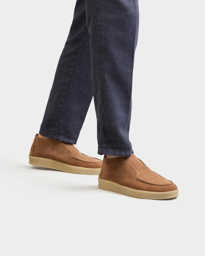 Men's brown moc toe ankle boots with slip-on styling and low soles