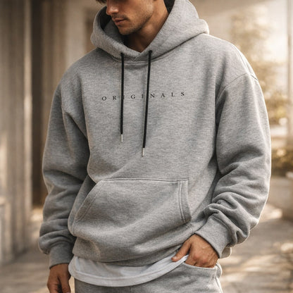 Relaxed fit pullover hoodie with drawstring hood, long sleeves, kangaroo pocket and chest lettering