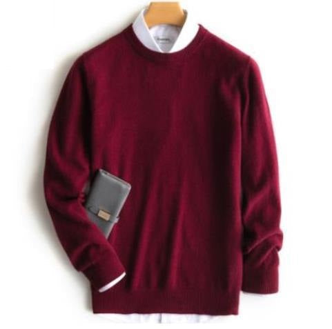Men's plain knit crew neck sweater layered over a collared shirt