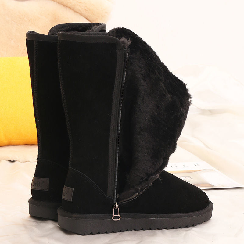 Black tall winter boots with side zippers and flat treaded soles