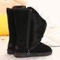 Black tall winter boots with side zippers and flat treaded soles