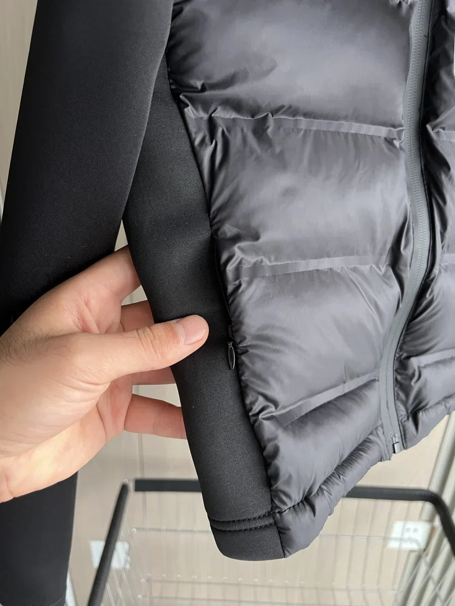 Women's black cropped hooded puffer jacket with long sleeves and front zip