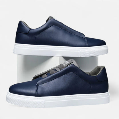 Men's low-top slip-on sneakers with stitched panels and flat white soles
