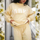 Women's pink oversized crewneck sweatshirt with letter graphic