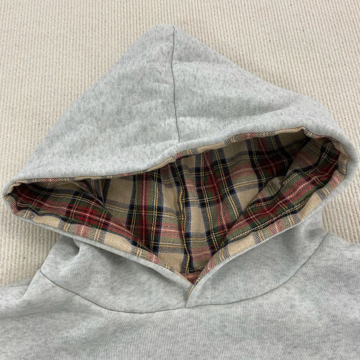 Loose hooded sweatshirt with plaid lining and kangaroo pocket