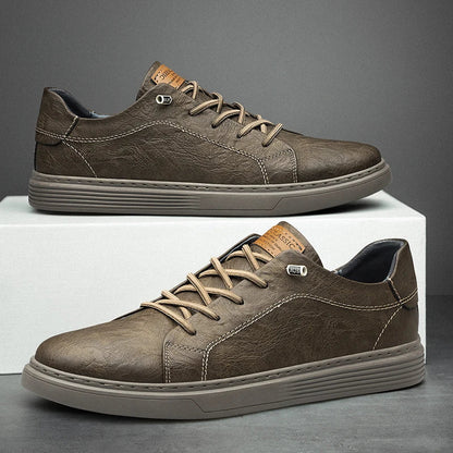 Men's low-top lace-up sneakers with stitched panels and a layered flat sole