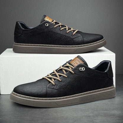 Men's low-top lace-up sneakers with stitched panels and a layered flat sole
