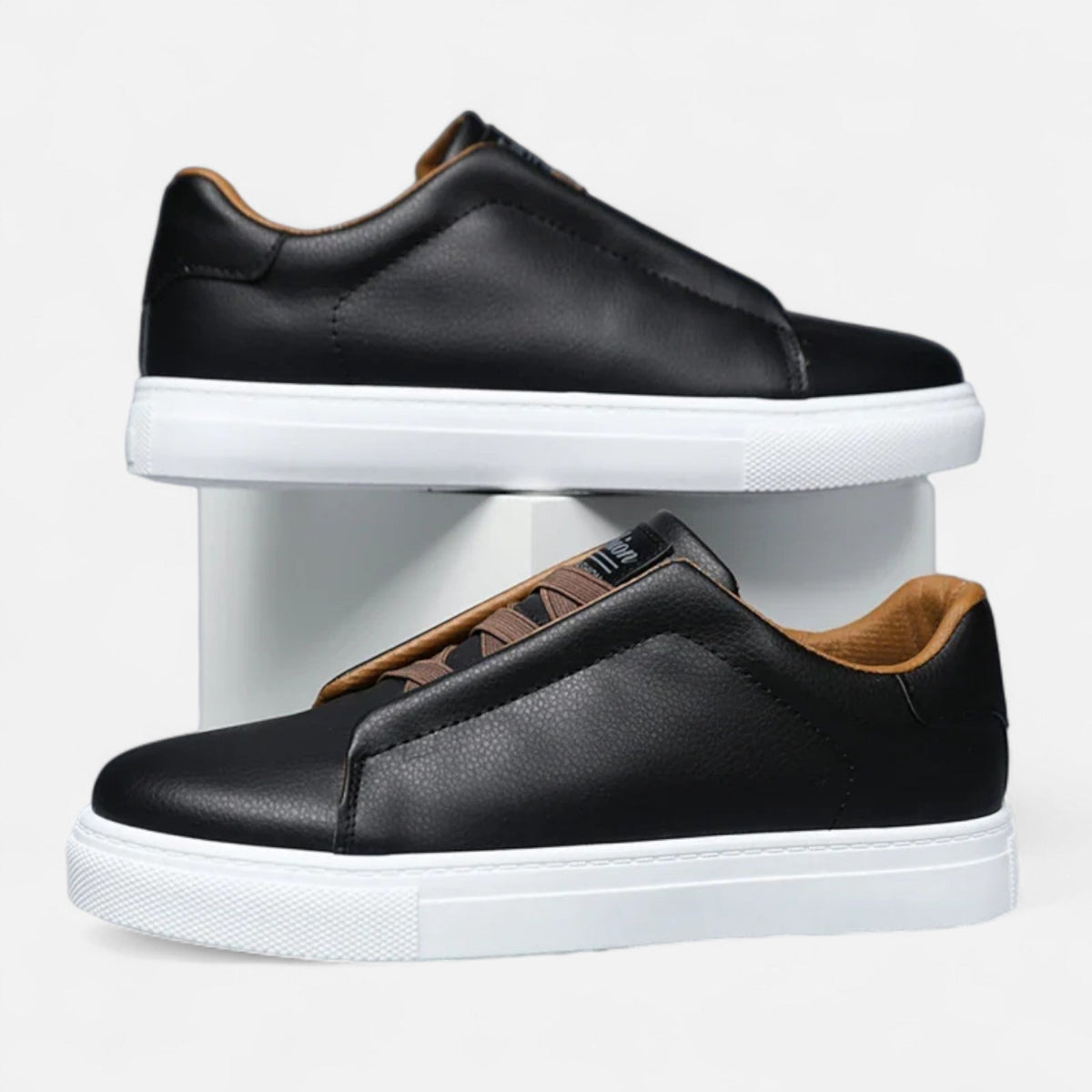 Men's low-top slip-on sneakers with stitched panels and flat white soles
