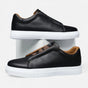 Men's low-top slip-on sneakers with stitched panels and flat white soles