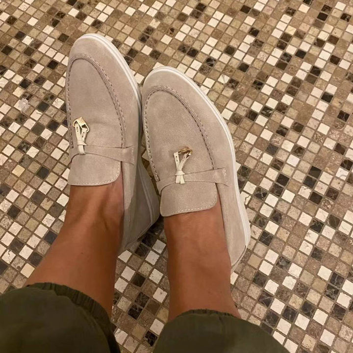 Women's flat slip-on loafers with rounded moc toe and metal trim