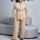 Woman wearing a beige peplum blazer suit set with wide-leg trousers
