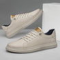 Men's low-top lace-up sneakers with stitched panels and a layered flat sole