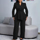 Woman wearing a beige peplum blazer suit set with wide-leg trousers