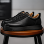 Low-top lace-up sneakers with textured side panels and layered flat soles