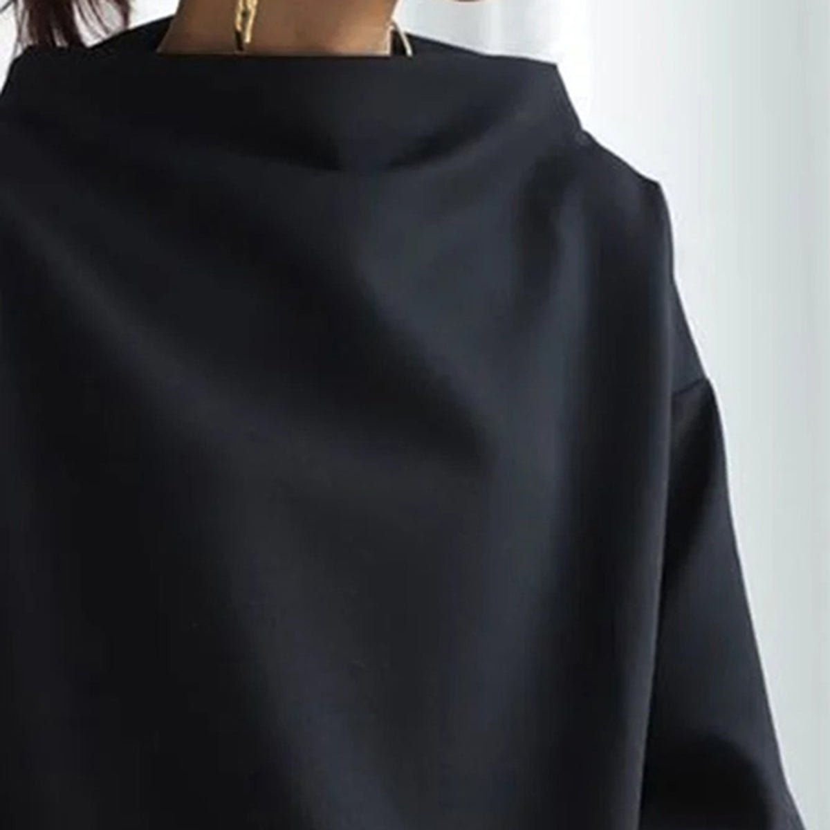 Women's black oversized mock neck sweater with long sleeves
