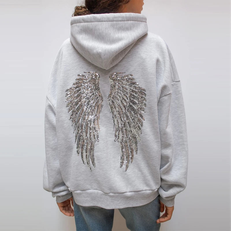 Women's gray hoodie with drawstring hood and silver sequin wings on the back