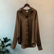 Women's long-sleeve button-front shirt blouse with pointed collar and curved hem