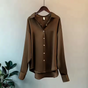 Women's long-sleeve button-front shirt blouse with pointed collar and curved hem