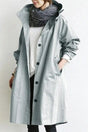 Women's long hooded raincoat with button front and patch pockets