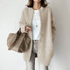 Women's long textured button front cardigan with patch pockets