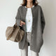 Women's long textured button front cardigan with patch pockets