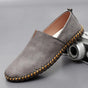 Slip-on loafers with rounded toes, flat soles and contrasting stitched trim