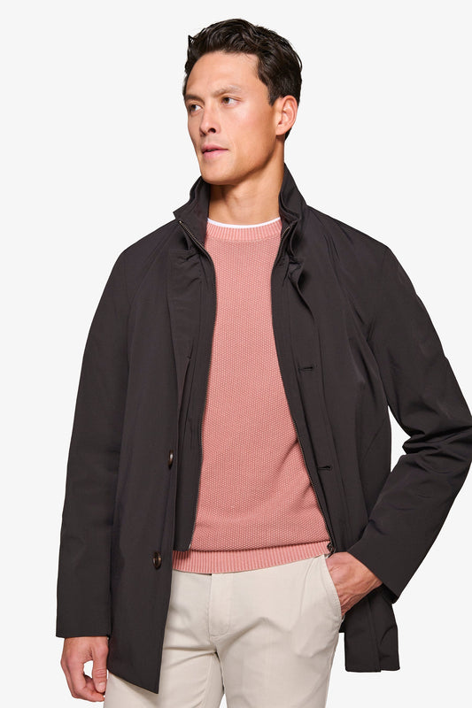 Men's black stand collar jacket with zip front and button details
